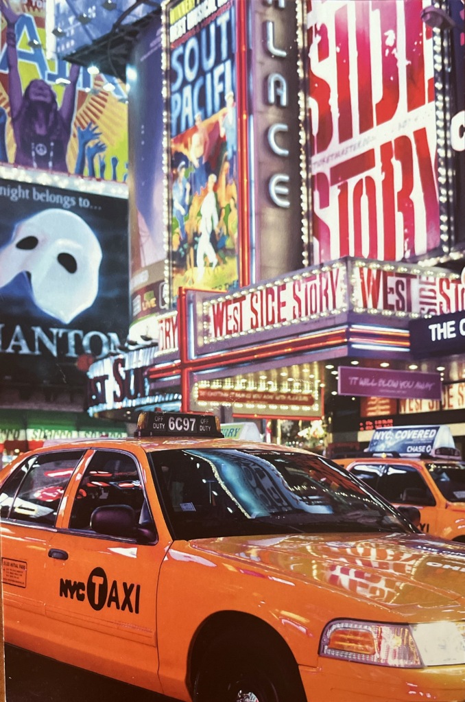 A colorful illustrated postcard of times square. The iconic yellow taxi rides through the street. Marquees for Broadway productions illuminate the sky. They are Phantom of the Opera, West Side Story, Hair, and South Pacific. 